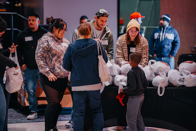 Zion City volunteers handing Thanksgiving groceries to families